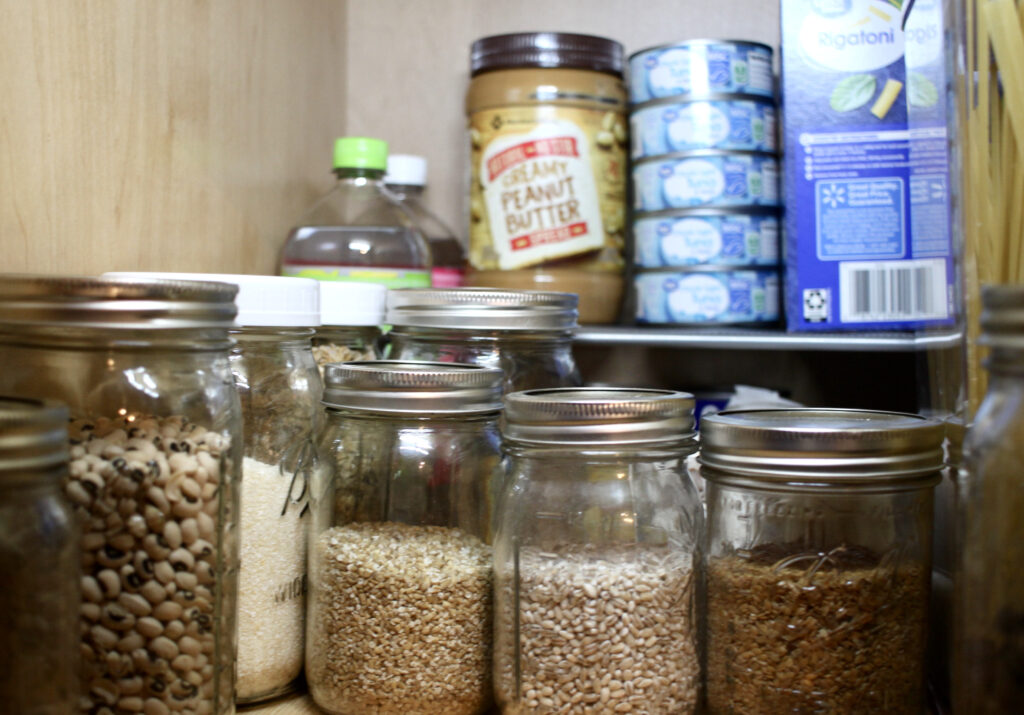 Pantry shelf with grains, peanut butter and tuna