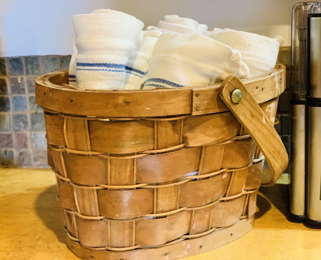 rolled tea towels in basket