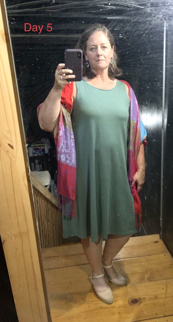 woman in green dress, red wrap and taking a selfie